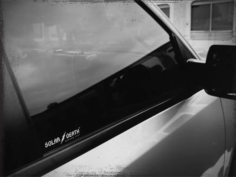 Solar Death sticker on a car window